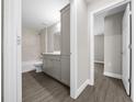 Well-lit bathroom with modern vanity, new fixtures, tub, and tiled shower, plus wood-look flooring at 10435 Se 125 Ln, Belleview, FL 34420