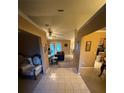 Inviting foyer with tile flooring leading to a cozy living area and kitchen at 10999 Sw 47Th Ave, Ocala, FL 34476