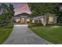 Beautiful single-story home featuring manicured landscaping, a stone facade, and a spacious driveway at 1103 Se 46Th St, Ocala, FL 34480