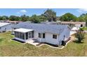 Well-kept backyard featuring a screened lanai, patio area, and neatly edged garden beds around the lawn at 11118 Sw 76Th Ave, Ocala, FL 34476