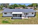 Features screened porch, a concrete patio, and a tidy well-maintained lawn with garden edging at 11118 Sw 76Th Ave, Ocala, FL 34476