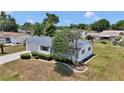 Well-maintained single-story home featuring a tidy front yard, driveway, and an attached two-car garage at 11118 Sw 76Th Ave, Ocala, FL 34476