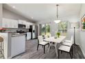 Well-lit dining area featuring modern decor, a view to the yard, and direct access to the kitchen at 11887 Se 71St Ave, Belleview, FL 34420