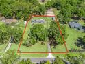 Aerial view of a sprawling property surrounded by lush greenery and mature trees providing privacy at 13897 W Highway 328, Ocala, FL 34482