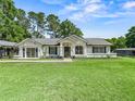 Charming single-story home with a well-manicured lawn and inviting front entrance at 13897 W Highway 328, Ocala, FL 34482