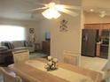 Open concept dining area with tile floors, chandelier, and access to kitchen and living room at 14244 Sw 115Th Cir, Dunnellon, FL 34432