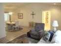Inviting living room area with tile floors, comfortable seating, and access to a dining area and bathroom at 14244 Sw 115Th Cir, Dunnellon, FL 34432