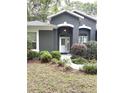 A beautifully maintained front yard leading to the front door at 18956 Sw 93Rd Loop, Dunnellon, FL 34432