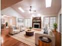 Bright living room with hardwood floors, a fireplace, and french doors leading to other rooms at 1951 Se 37Th Court Cir, Ocala, FL 34471