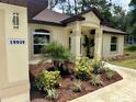 Well-maintained single-story home with manicured landscaping and a covered front entry, address clearly displayed at 19939 Sw 96Th Pl, Dunnellon, FL 34432