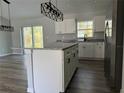 Stylish kitchen featuring an island with granite countertops, stainless steel appliances, and modern lighting at 20652 Sw Cardinal Ave, Dunnellon, FL 34431