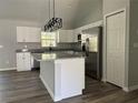 Modern kitchen featuring white cabinets, stainless steel appliances, granite countertops, and a functional island at 20652 Sw Cardinal Ave, Dunnellon, FL 34431