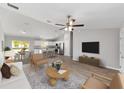 Open-concept living room featuring hardwood floors, a ceiling fan, and lots of natural light at 207 Juniper Loop Cir, Ocala, FL 34480
