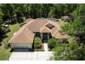 Aerial view of home on large lot with mature trees, screened pool and additional storage at 21884 Sw 88Th Lane Rd, Dunnellon, FL 34431