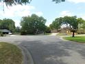A suburban street featuring well-maintained lawns and mature trees, with glimpses of neighboring homes at 2865 Se 37Th St, Ocala, FL 34471