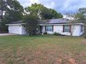 Lovely home with neatly maintained lawn and solar panels accentuating the roof at 33 Pecan Pass Trl, Ocala, FL 34472