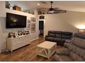 Cozy living area with vaulted ceilings, wood floors, neutral paint, and comfortable leather furnishings at 33 Pecan Pass Trl, Ocala, FL 34472