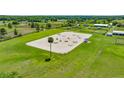 Vast riding arena with professional jumps, bordered by lush green fields and secure fencing at 5415 Nw 100Th St, Ocala, FL 34482