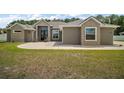 Close-up of the house featuring a beautifully textured facade, double door entry, and a meticulously maintained lawn at 6292 Se 13Th St, Ocala, FL 34472