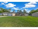 Inviting single-story home with a manicured lawn, a 2-car garage, and attractive landscaping at 7370 Sw 129Th Ln, Ocala, FL 34473