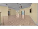 Spacious living room with tile floors, neutral walls, and a ceiling fan for modern comfort at 7370 Sw 129Th Ln, Ocala, FL 34473