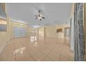 Expansive living space featuring neutral walls, tile flooring, a ceiling fan, and natural light at 7370 Sw 129Th Ln, Ocala, FL 34473