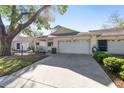Well maintained single-story home with a spacious driveway, attached two-car garage, and charming front lawn at 9069 Sw 96Th Ln # B, Ocala, FL 34481