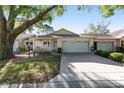 Inviting single-story home features a well-manicured lawn, attached two-car garage, and a cozy front porch at 9069 Sw 96Th Ln # B, Ocala, FL 34481