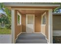 Welcoming covered porch with freshly painted steps and pillars, leading to the home's entrance at 935 Ne Sanchez Ave, Ocala, FL 34470