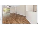 Bright living room featuring laminate floors, a sliding glass door, and fresh paint at 9541 Sw 93Rd Loop, Ocala, FL 34481