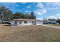 Charming home featuring a two-car garage and well-kept lawn in daylight at 10141 Sw 62Nd Terrace Rd, Ocala, FL 34476