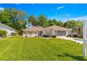 Charming one story home with a well maintained lawn, mature trees, and a beautiful landscape at 11058 Sw 69Th Cir, Ocala, FL 34476