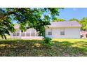 Exterior view of the home's back featuring a screened in porch at 11591 Sw 78Th Ave, Ocala, FL 34476