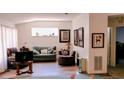 A living area with hardwood floors, neutral walls, a horizontal window and decor at 11591 Sw 78Th Ave, Ocala, FL 34476