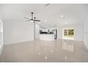 Bright and open living space with tile floors and neutral decor, seamlessly flowing into the kitchen at 12 Bahia Pass Ter, Ocala, FL 34472