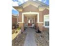 Inviting front porch with seating area and decorative elements, creating a warm and welcoming entrance at 13111 Se 86Th Cir, Summerfield, FL 34491