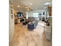 Comfortable open-concept living room featuring tile floors and modern decor at 13111 Se 86Th Cir, Summerfield, FL 34491