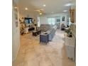 Spacious living room with neutral tones, comfortable seating, and large windows providing natural light at 13111 Se 86Th Cir, Summerfield, FL 34491