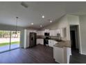 Modern kitchen with stainless steel appliances, granite countertops, and a view to the dining room at 1475 Sw Big Bear Rdg, Dunnellon, FL 34431