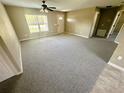 Bright living room featuring neutral carpet, a ceiling fan, and a front entrance with natural lighting at 15585 Sw 46Th Cir, Ocala, FL 34473