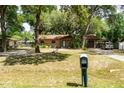 Charming single-story home with a well-maintained front yard and mature trees at 2161 Ne 38Th St, Ocala, FL 34479