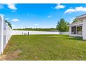 Expansive backyard with a white fence and plenty of green space for outdoor activities and relaxation at 27 Juniper Dr, Ocala, FL 34480