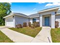 Beautiful home with an attached garage, complemented by green landscaping, creating a serene curb appeal at 27 Juniper Dr, Ocala, FL 34480