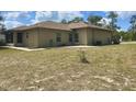 Expansive backyard showcasing the home's rear exterior, complemented by a spacious lawn at 2730 Sw 173Rd Place Rd, Ocala, FL 34473