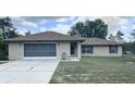 Lovely one-story home featuring screened garage, well-kept lawn, and front door entrance at 2730 Sw 173Rd Place Rd, Ocala, FL 34473