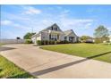 Spacious driveway leading to a lovely single-story home with lush green lawn at 4020 Se 23Rd St, Ocala, FL 34471