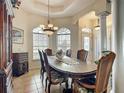 Elegant dining room with chandelier lighting, columns, large window, and decorative trim at 4033 Ne 15Th Court Rd, Ocala, FL 34479