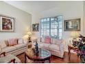 Cozy living room featuring hardwood floors, neutral-toned furniture, and natural light from a large window at 4033 Ne 15Th Court Rd, Ocala, FL 34479