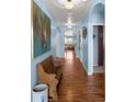 Inviting hallway featuring wood floors, archways, and elegant lighting at 4398 Ne 29Th St, Ocala, FL 34470