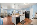 Open kitchen with stainless steel appliances, white cabinets, and an eat-in dining area at 4398 Ne 29Th St, Ocala, FL 34470